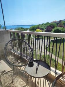 a table and chairs on a balcony with a view at Marina Sarafovo in Burgas City