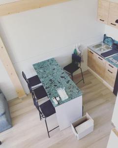 a kitchen with a table and chairs in a room at Domki na Łące in Gogołów