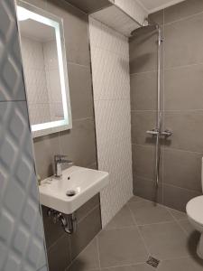 a bathroom with a sink and a shower at Marina Sarafovo in Burgas City