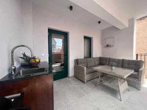 a living room with a couch and a table at Azalea Dalmacija Luxury Rooms and Apartments in Primošten