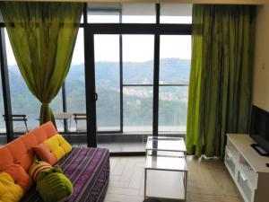 a living room with a couch and a large window at Condo with great view in PJ in Petaling Jaya
