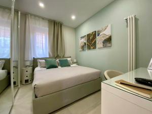 a small bedroom with a bed and a desk at Le Suite con terrazzo Abitare Roma in Rome