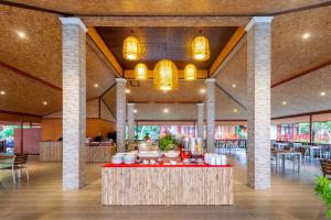 a lobby with a table with food on it at PP Erawan Palms Resort- SHA Extra Plus in Phi Phi Islands