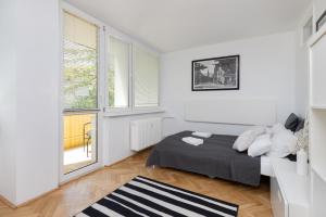 a white room with a bed and a window at Studio with Balcony 300m to the Beach Sopot by Renters in Sopot