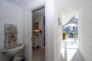 a white bathroom with a toilet and a balcony at Juno Hotel Taksim in Istanbul +144 photos