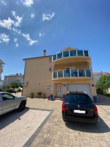 a car parked in a parking lot in front of a house at Vila Meri in Vodice