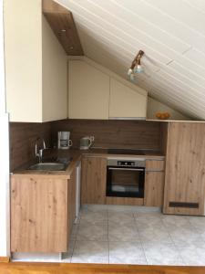 een keuken met houten kasten en een spoelbak bij Apartment Bojana in Novi Vinodolski