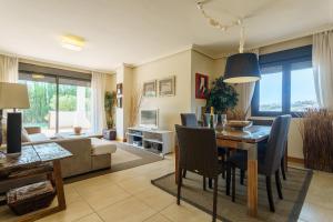 jadalnia i salon ze stołem i krzesłami w obiekcie Luxurious and spacious apartment with a private garden and solarium with great views in Estepona área Marbella La Resina Country Golf w mieście Estepona