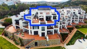 an aerial view of a house with a blue circle on it at Exclusive luxury frontline beach penthouse Casares del mar - Estepona in Casares