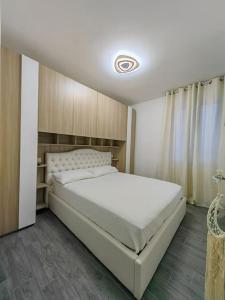 Ένα ή περισσότερα κρεβάτια σε δωμάτιο στο Attico Nettuno