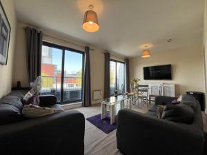 a living room with two couches and a large window at Two Bed Flat White Star Place in Southampton