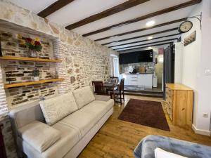 - un salon avec un canapé et un mur en briques dans l'établissement Tequila Apartments, à Zadar