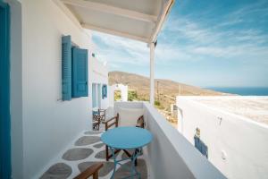 塞里福斯島的住宿－Alcyone，阳台设有蓝色桌子,享有海景。