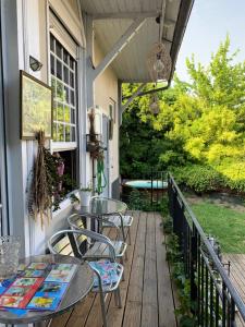 a patio with tables and chairs on a porch at " Venez DormiR Chez Nous " #Condom#Gascogne#d'Artagnan#Armagnac#Le Bonheur est dans le GERS in Condom