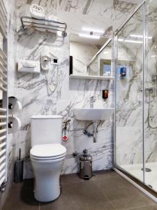 a bathroom with a toilet and a sink and a shower at Lipa, Hotel & Bistro in Nova Gorica