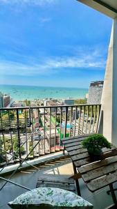 a balcony with a view of the ocean from a building at The BASE Central PATTAYA 2Bed on Sky in Pattaya Central