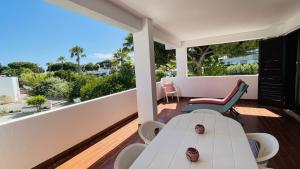 a balcony with a table and chairs and a view of the ocean at Mar by Check-in Portugal in Albufeira