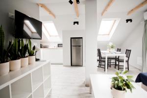 a kitchen and dining room with a table and chairs at Spokojna Apartamenty in Trzebinia