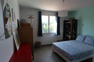 a bedroom with a bed and a window at Villa Roquefortoise avec piscine in Roquefort-les-Pins +19 photos