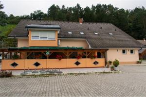 a house with a building with a roof at Hiša Izabela in Muta