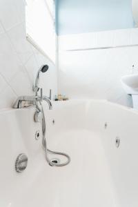a bathroom with a sink and a bath tub at Birkby Lodge Escape in Lytham St Annes