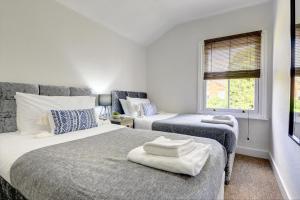 a bedroom with two beds and a window at The Dudley House I Spacious Executive House with Big Kitchen, Dining Space and Garden in Castle Quarter I eco-Short Term Let by SILVA in Bedford
