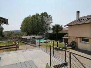 a view from the balcony of a house with a swimming pool at Gîte des Pierres Dorées in Saint-Germain-Nuelles