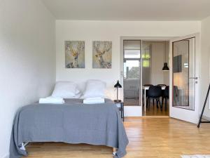 a bedroom with a bed with a blue blanket at Studio Apartment Glostrup in Glostrup