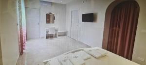 a bathroom with a sink and a table with towels at B&B Uliveto in Cerignola