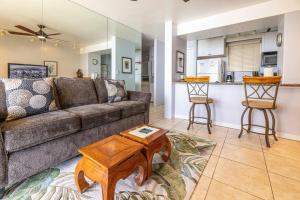 a living room with a couch and a table at Kealia Resort 203 in Kihei