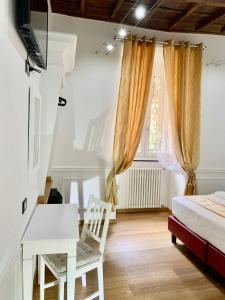 a bedroom with a bed and a desk and a table at Domus Ester in Rome