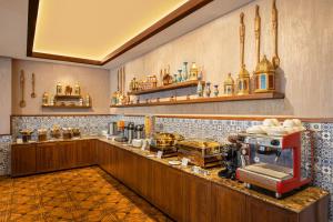 a kitchen with a counter top with a stove at WelcomHeritage Grand, Srinagar in Srinagar