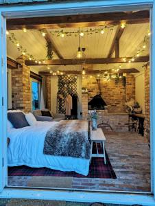 a bedroom with a large bed and a fireplace at The Old Forge in Bishop Wilton