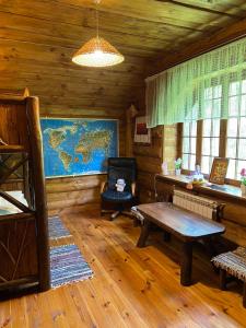 a living room with a table in a cabin at Lisotel in Rokytne