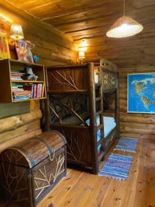 a room with two bunk beds in a log cabin at Lisotel in Rokytne