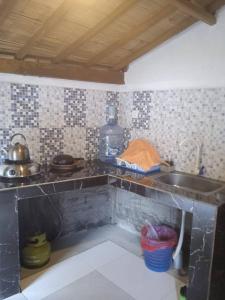 a kitchen with a sink and a counter top at Kayu Tua Villa in Uluwatu