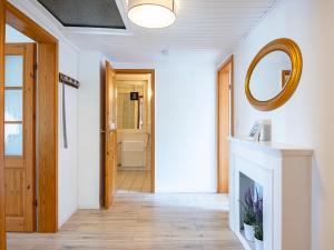 a hallway with a fireplace and a mirror at Lieblingsort Freude in Timmendorfer Strand