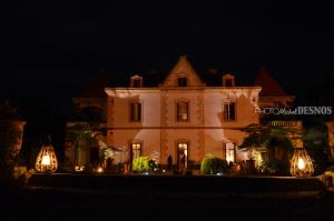 a large white house at night with lights at La Bellonette in Marseillan +18 photos