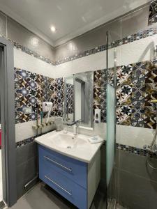 a bathroom with a sink and a shower and a mirror at Luxury Studio House 589-6 in 6th Of October