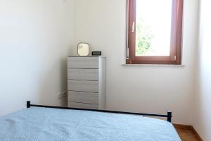 a bedroom with a bed and a dresser and a window at SE014 - Senigallia, nuovo bilocale comodo a centro e spiaggia in Senigallia