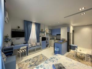 a bedroom with blue cabinets and a kitchen at Studio House 589-6 in 6th Of October