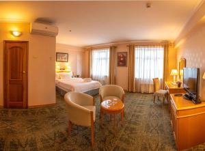 a hotel room with a bed and a television at Continental Hotel in Ulaanbaatar