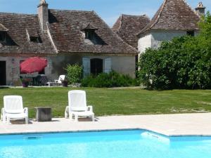 a group of chairs sitting next to a swimming pool at luxury cottage for 2, beautiful views, large swimming pool, no children in Issigeac