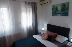 a bedroom with a bed with two pillows on it at Apartment Anita Međugorje in Međugorje