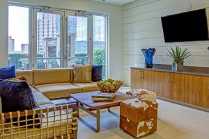 a living room with a couch and a tv at Downtown Austin 1br w gym pool wd nr Capitol ATX-165 in Austin