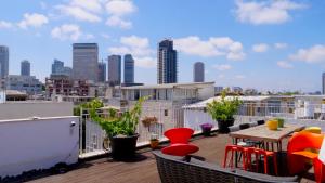 a balcony with a table and chairs and a city skyline at Tel Aviv Center Seaside Villa with a Pool & Rooftop in Tel Aviv
