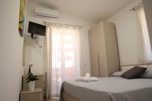 een kleine slaapkamer met een bed en een raam bij Casa Vacanze IL GIGANTE in Agrigento