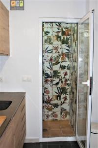 a shower with a glass door in a kitchen at Casa Violeta in Altea