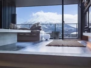 a living room with a view of a mountain at Suiboku in Niseko