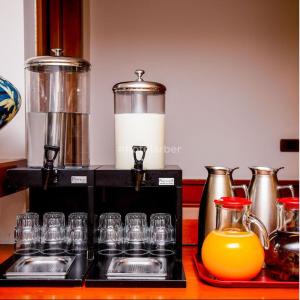 a group of glasses sitting on a counter with a blender at Arber Hotel in Tirana
